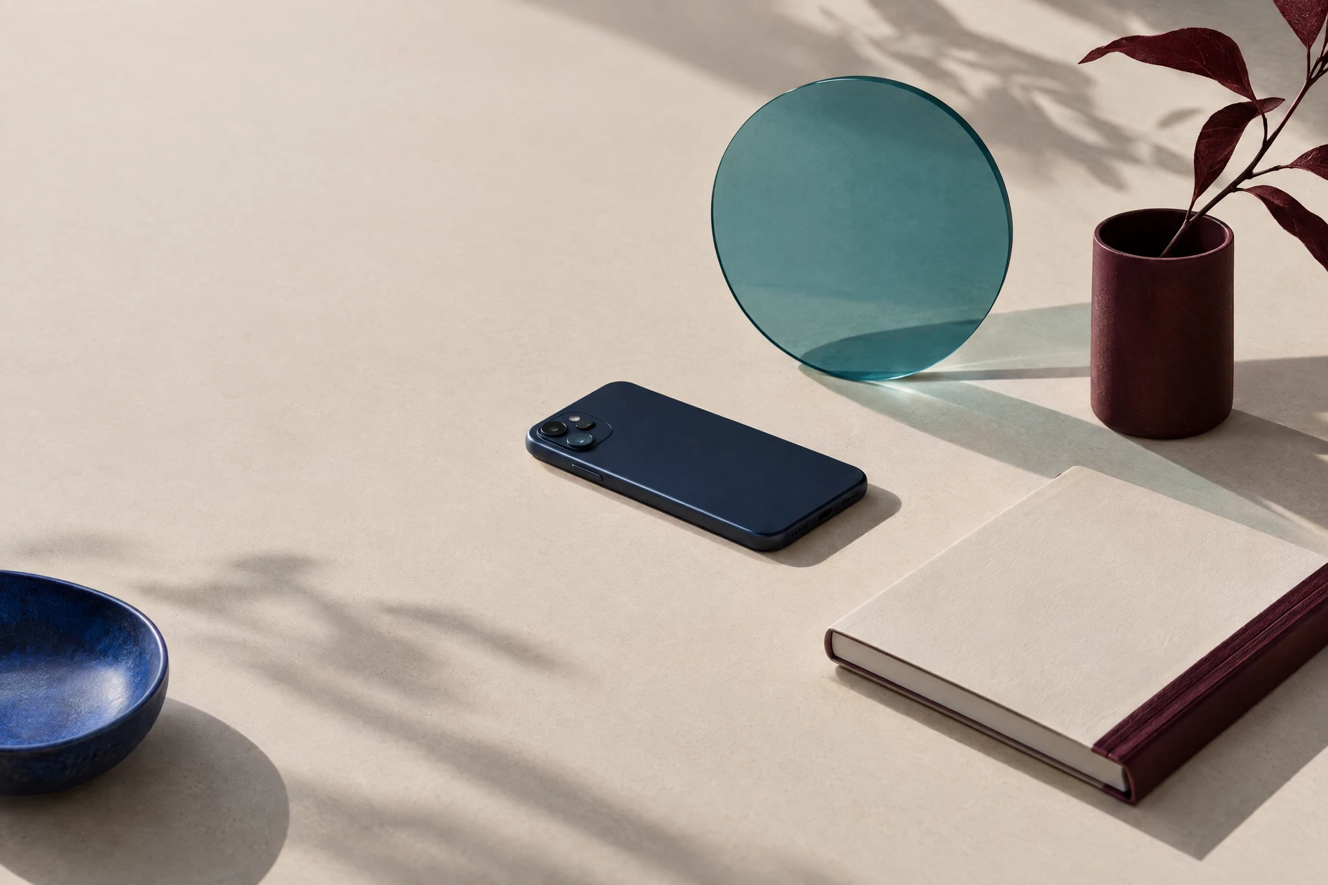 Generic phone face-down with translucent teal circle and blank notebook
